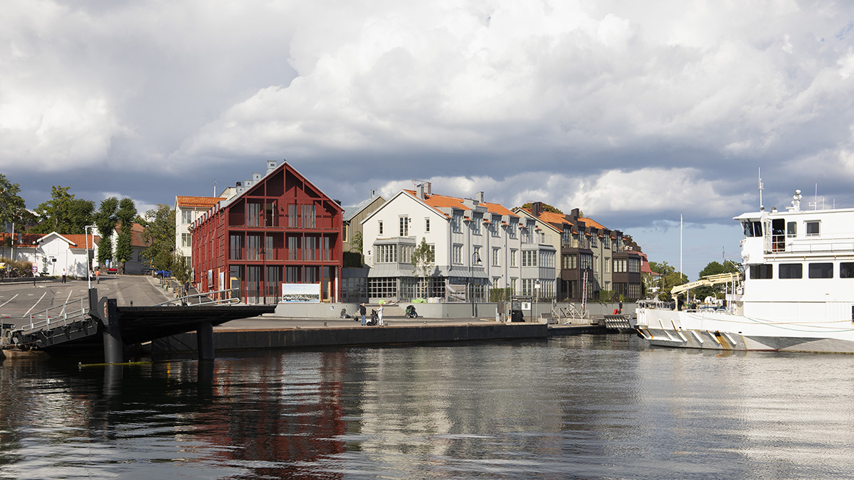 Röda och vita bostadshus vid hamnbryggan på Dalarö